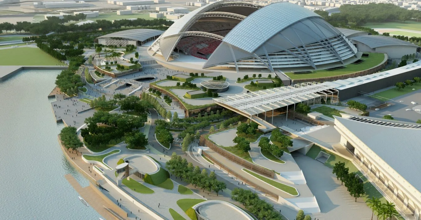 Aerial view of a futuristic Singapore's Sports Hub complex with a stadium near water, showing a successful example of Public-Private Partnerships Singapore project.