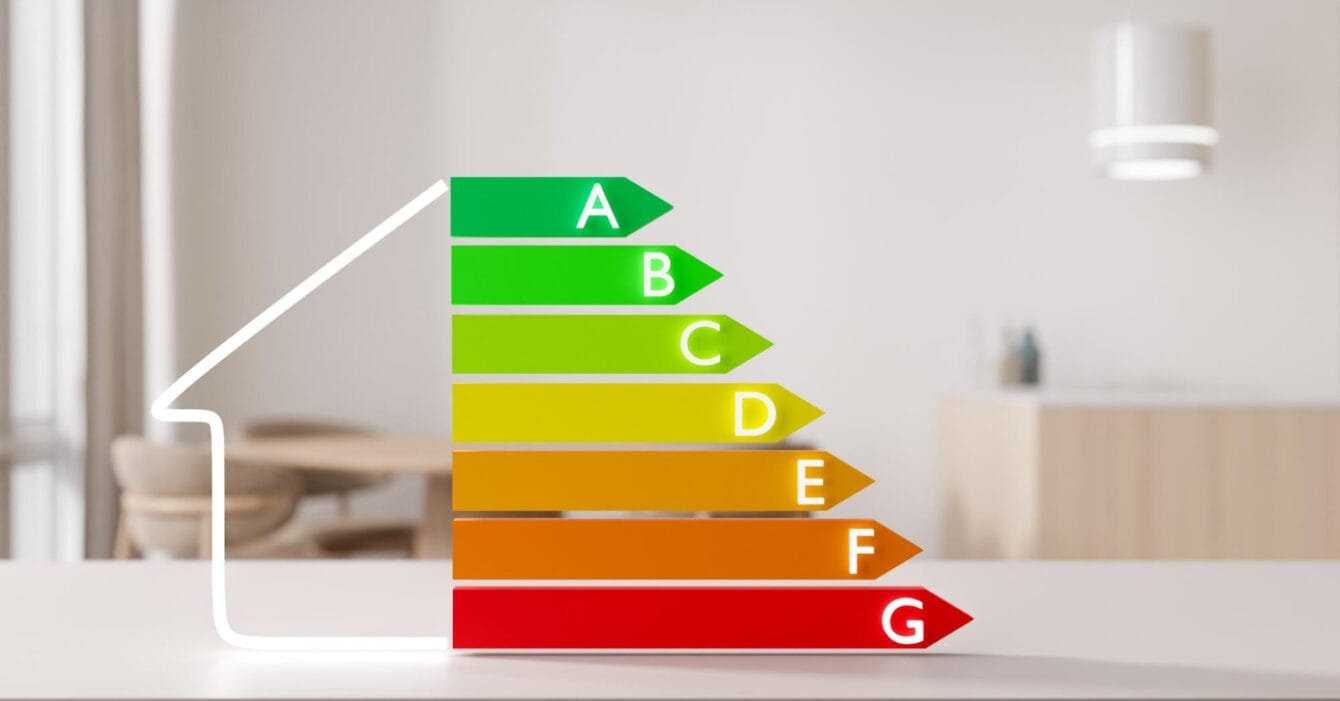 A colorful energy efficiency rating scale from A (green) to G (red) to indicate Singapore Energy-Efficient Construction displayed in a modern interior setting.